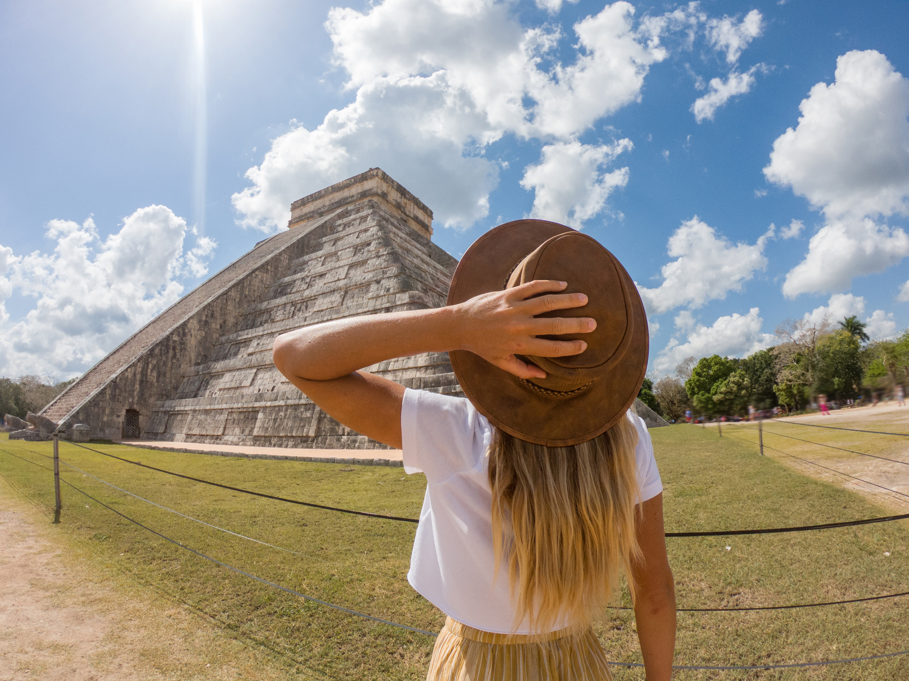 Travel girl contemplating Chichen Itza pyramid, Mexico